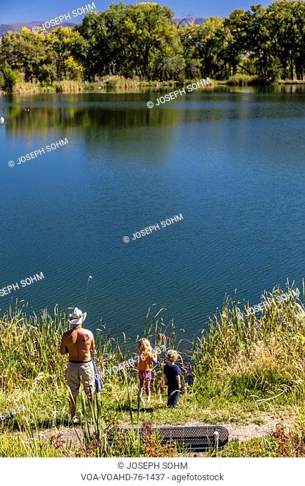 Father and children are fishing South of Montrose Colorado, off the Uncompahgre, on Chipeta Lakes, Montrose, Colorado. September, 26, 2016