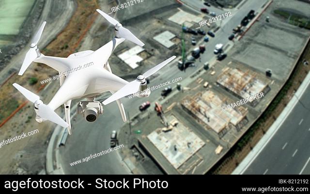 Unmanned aircraft system (UAV) quadcopter drone in the air over construction site