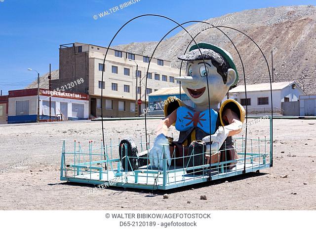 Chile, Calama-area, Chuquicamata, former copper mining ghost town, Pinocchio statue on playground