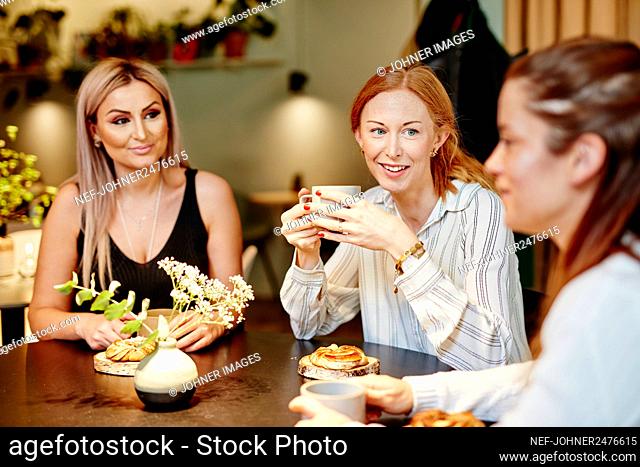 Female friends talking in cafe