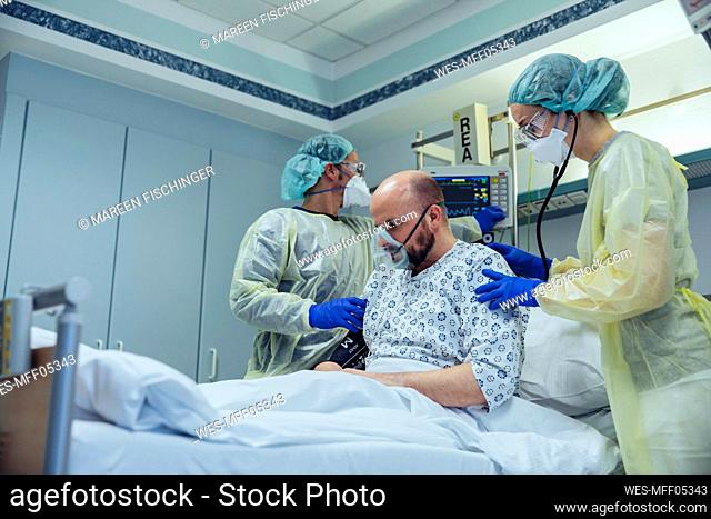 Doctors giving artificial respiration to patient in emergency care unit of a hospital