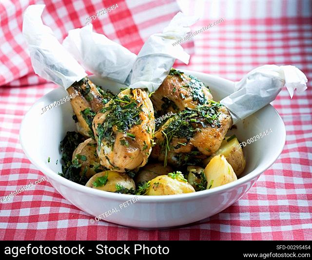 Grilled chicken drumsticks with herbs and potatoes