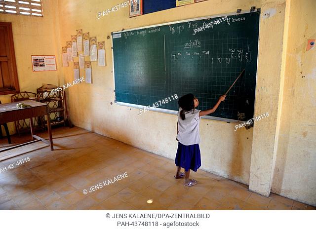 A girl writes on the blackboard in a nicely decorated classroom of the Kdei Chas Primary School in Phnom Penh, Cambodia, 11 October 2013