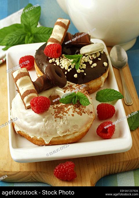 Big donuts with chocolate and rasberries