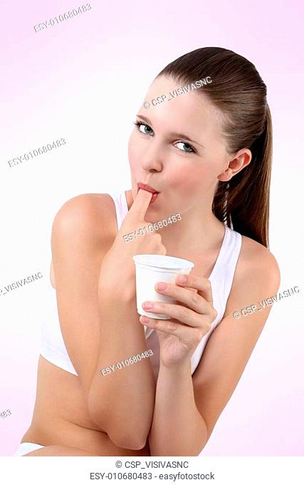 nice girl eating yogurt sucking finger