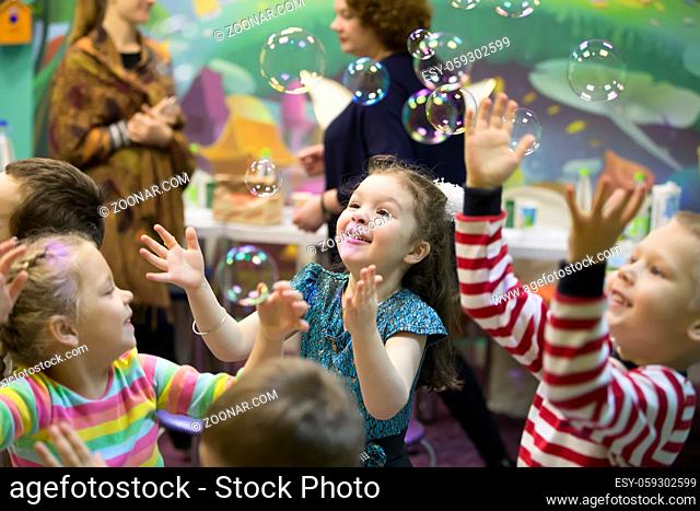 Soap bubbles show. Children's party. To burst the soap bubble