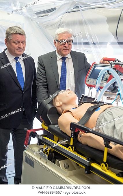 German Foreign Minister Frank-Walter Steinmeier (R) and Health Minister Hermann Groehe tour the ""Robert Koch"" evacuation plane at Tegel Airport in Berlin