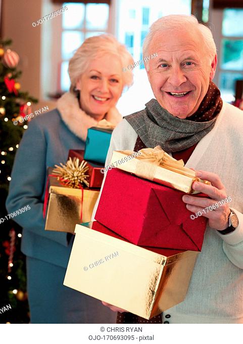 Couple holding Christmas gifts