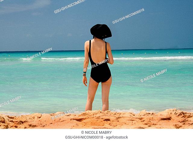 Woman Standing on Beach Looking at Sea, Rear View