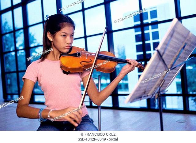 Teenage girl playing the violin