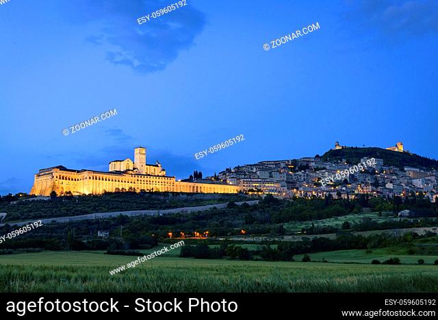 Illuminated cityscape Assisi basilica and monastery in Umbria, Italy