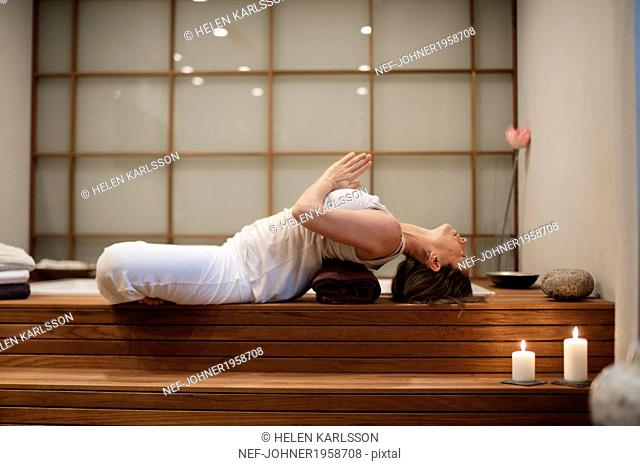Woman doing yoga in spa