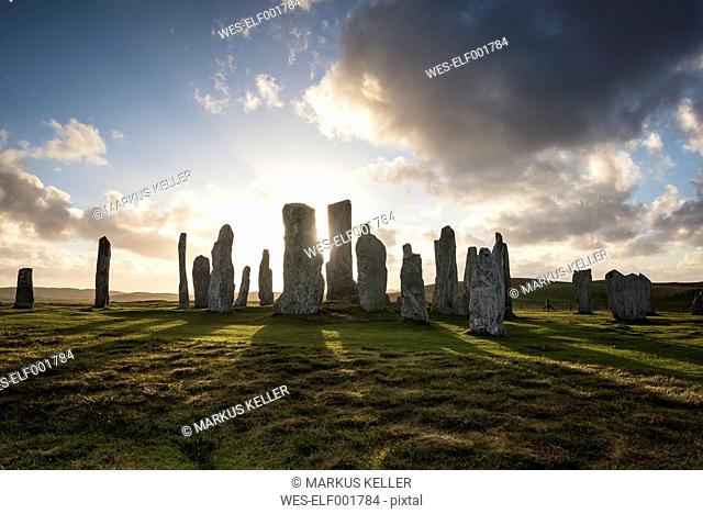 UK, Scotland, Isle of Lewis, Callanish, view to formation of standing stones at backlight