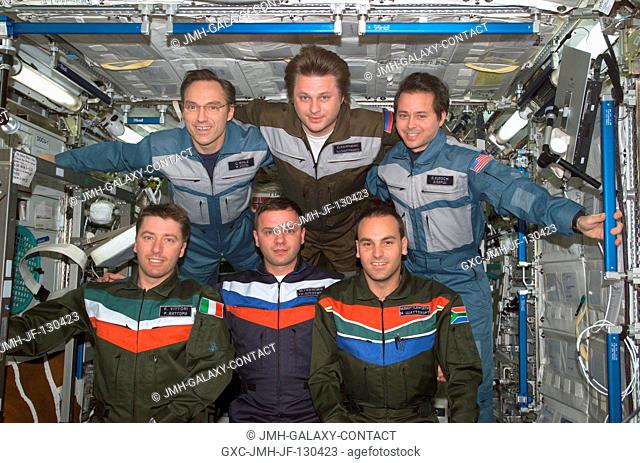 The Expedition Four and Soyuz 4 Taxi crews pose for a group photo in the Destiny laboratory on the International Space Station (ISS)