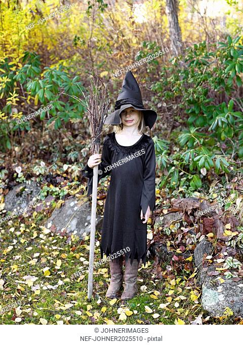 Girl wearing witch costume