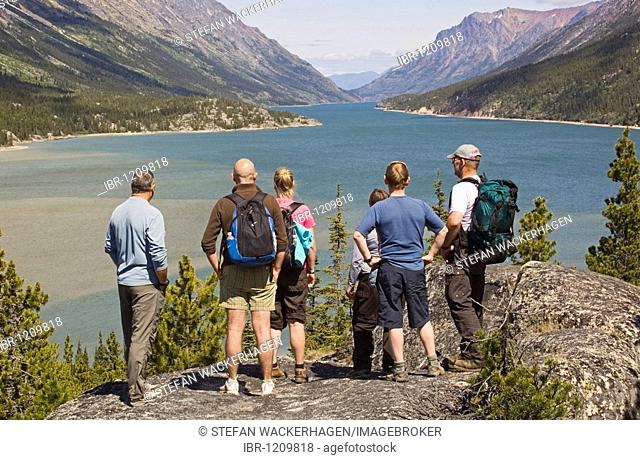 Group of hikers enjoying view over Lake Bennett, Chilkoot Pass, Chilkoot Trail, Yukon Territory, British Columbia, B. C., Canada