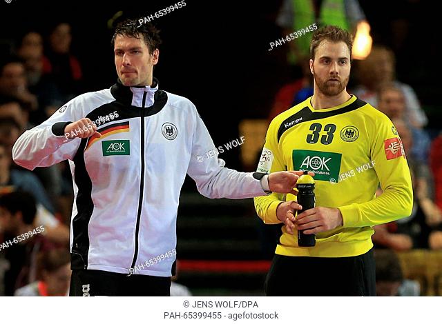 Germany's goa lkeeper Carsten Lichtlein (L) coaches team mate Andreas Wolff during the 2016 Men's European Championship handball group 2 match between Germany...