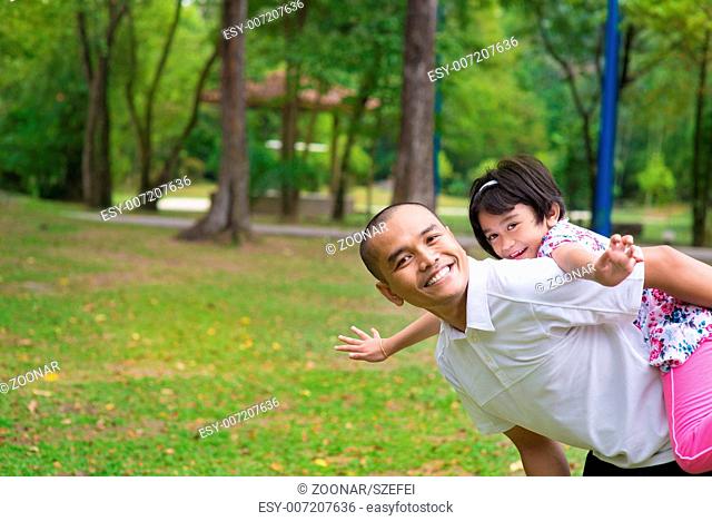 Muslim father and daughter piggyback