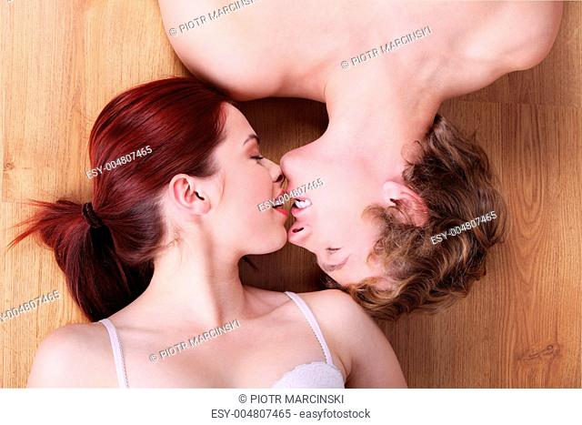Couple lying on the floor and kissing