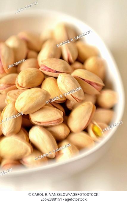 Healthy snacks: bowl of unsalted pistachio nuts. Shot with LensBaby for selective focus