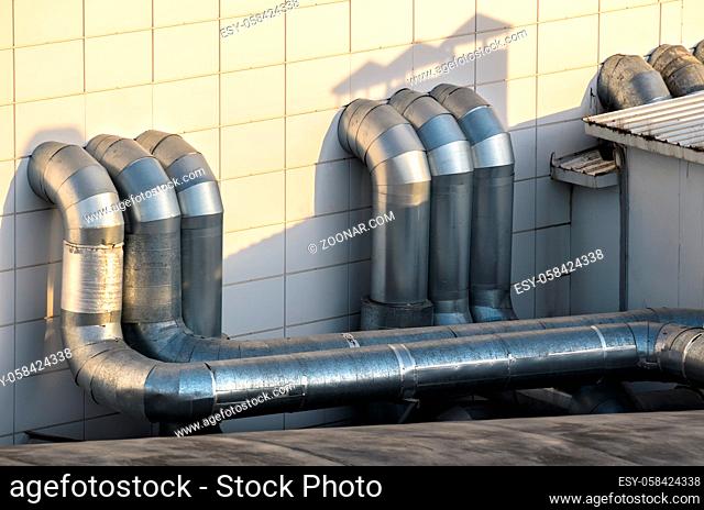 industrial ventilation pipe system on the roof of an industrial building
