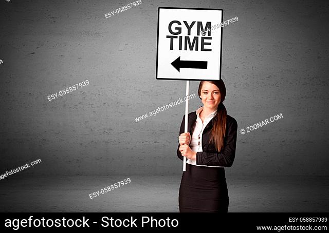 business person holding a traffic sign with GYM TIME inscription, new idea concept