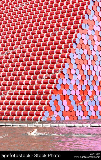 The London Mastaba by Christo and Jeanne-Claude is a temporary sculpture in Hyde Park comprised of horizontally stacked barrels on a floating platform in...