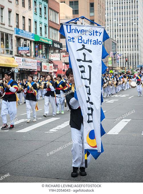 College students march down Sixth Avenue in New York with their school pennants in the Korean Parade