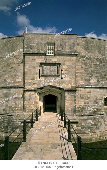 Gatehouse to Calshot Castle, Hampshire, 1995. The gate is approached across the moat. It was protected by a portcullis, with a pair of gun loops to either side...