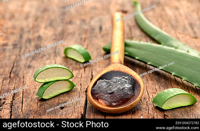 Aloe Vera Slices On Wooden Table And Spoon With Aloe Gel