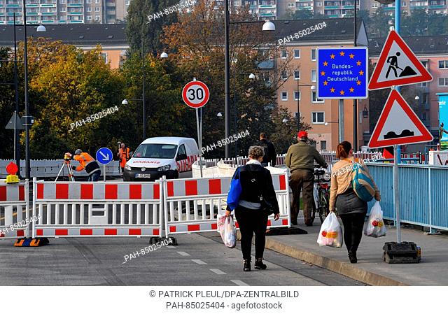 People walking past the construction site on the border crossing bridge from the Polish city of Slubice towards Frankfurt/Oder, Germany, 24 October 2016