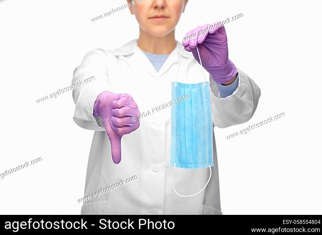 female doctor with mask showing thumbs down