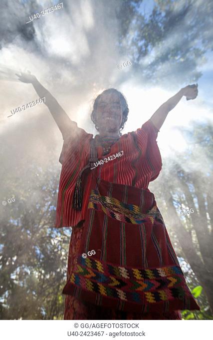 Woman standing in smoke in forest