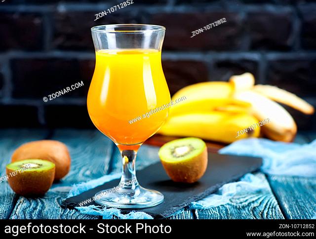 juice from kiwi and banana in the glass and on a table