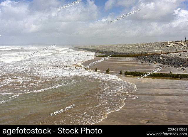 The beach and pebble ridge at Westward Ho! during high tide on the North Devon Coast, England