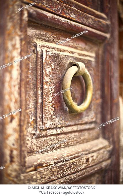 Knocker on old wooden door  Photo taken on Sardinia, Italy  Very shallow depth of field