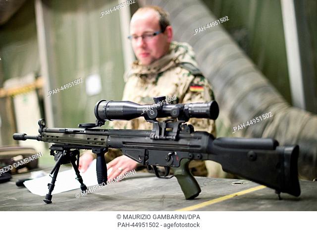 A German soldier prepares weapons for their transport back to Germany in the so-called material lock at Camp Marmal in Mazar-e Sharif, Afghanistan