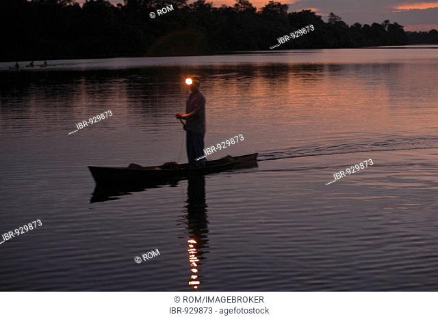 Fisherman in his canoe on the Danau Sentarum Lake, Kapuas Hulu, West Kalimantan, Kalimantan Barat, Borneo, Indonesia, Southeast Asia