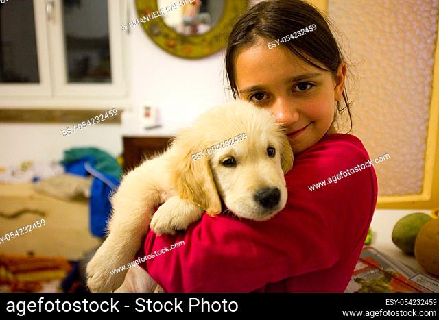 10 year old girl with Golden Retriever puppy