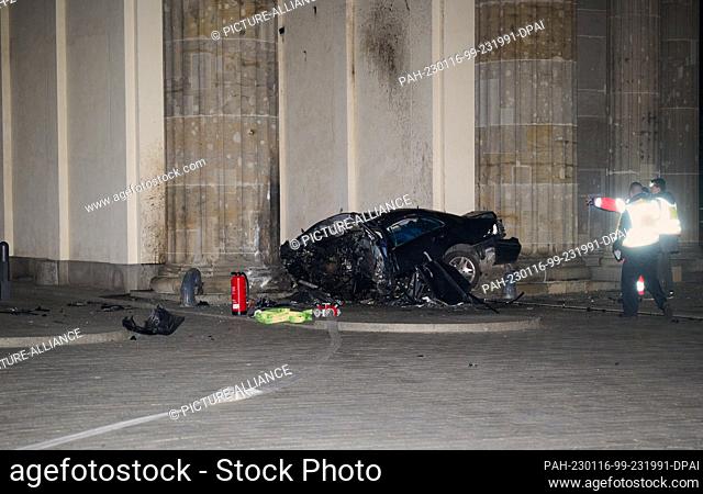 16 January 2023, Berlin: A destroyed car lies between two pillars of the Brandenburg Gate. A car crashed into a pillar of the Brandenburg Gate in Berlin