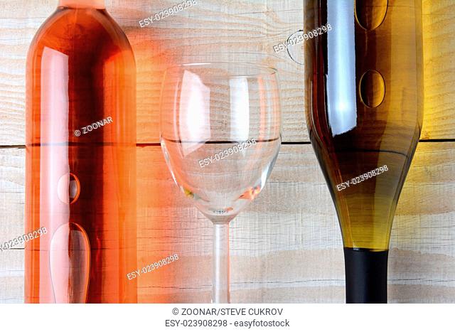 Wine Glass Between Two Bottles