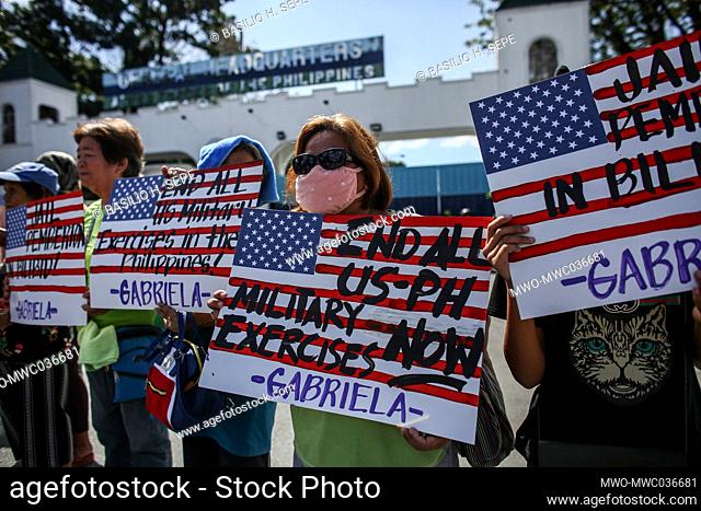 Activists hold placards against the continued presence of US bases in the country in front of a military headquarters in Manila, Philippines