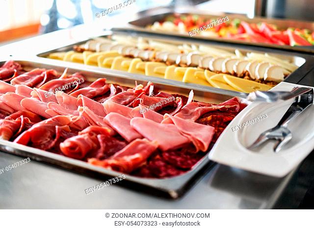 Buffet trays with a various delicious appetizers close-up. Breakfast in hotel. Smorgasbord