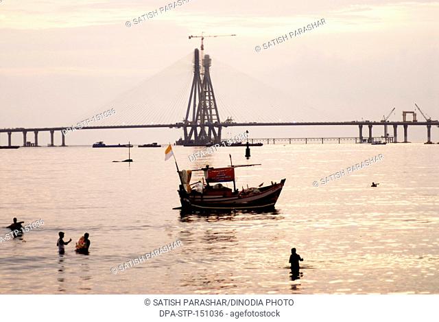Immersion ceremony of lord ganesh elephant headed god at Mahim beach ; Ganesh Ganpati festival ; Bombay now Mumbai ; Maharashtra ; India