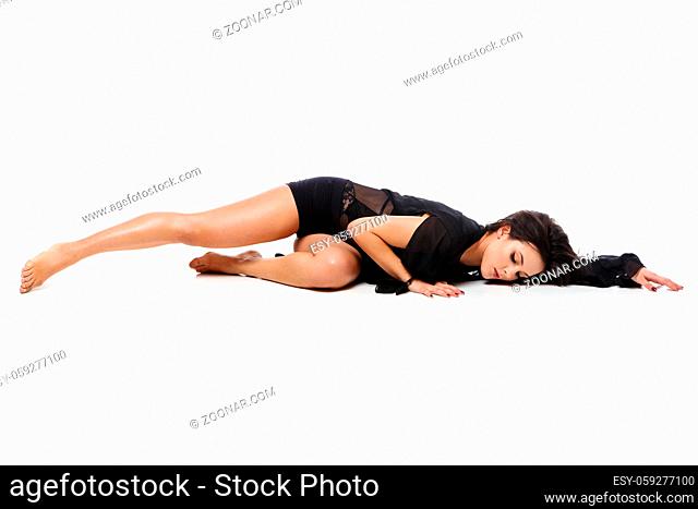 Beautiful modern dancer young woman in black flyings fabrics making dance moves. Isolated on white background. Copy space