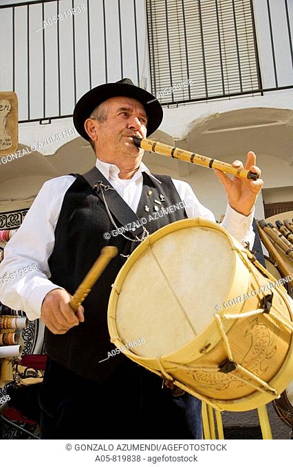 Man playing drum and Galician bagpipe during the Cerezo en flor festival, Casas del Castañar. Jerte river valley, Caceres province, Extremadura, Spain