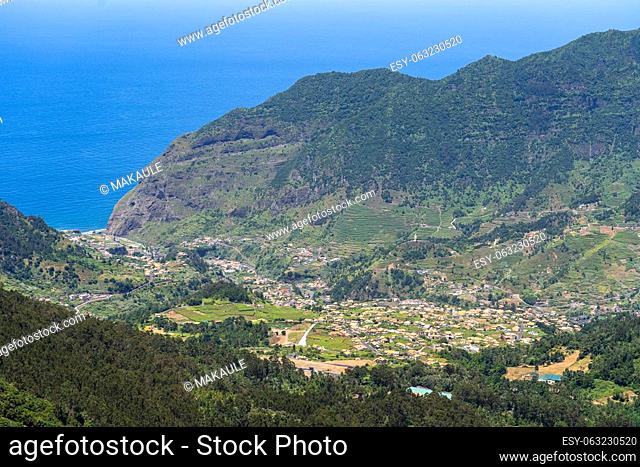 Aerial view on small city Sao Vicente - Chapel on the hill, huge mountains on background. Madeira island, Portugal