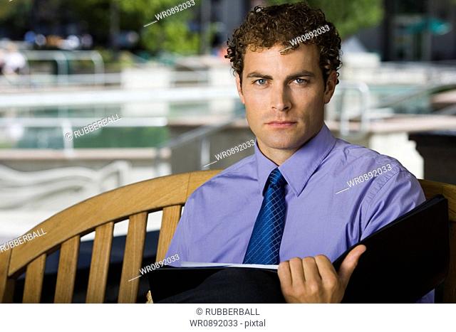 Portrait of a businessman holding a file