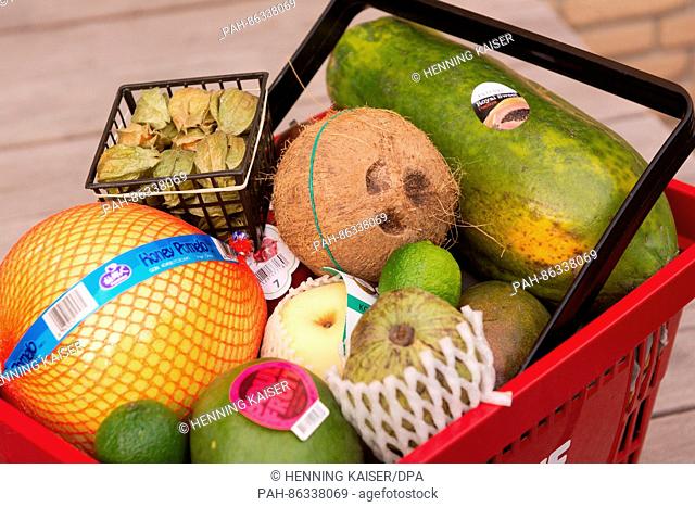 A mango, nashi pear, physalis, pomelo, cherimoya, coconut and other varieties of exotic fruit seen in a shopping basket in Cologne, Germany, 07 December 2016