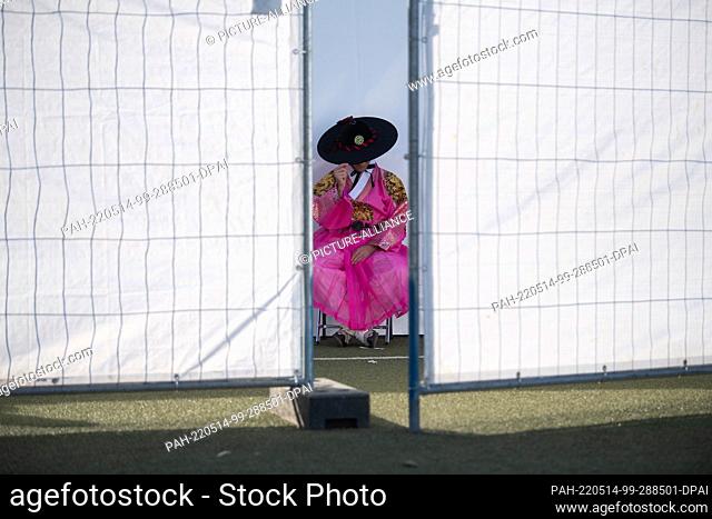14 May 2022, Hessen, Frankfurt/Main: A member of Hanbok Fashion Show, which shows traditional clothes from Korea during the K-Pop mega-festival ""KPOP